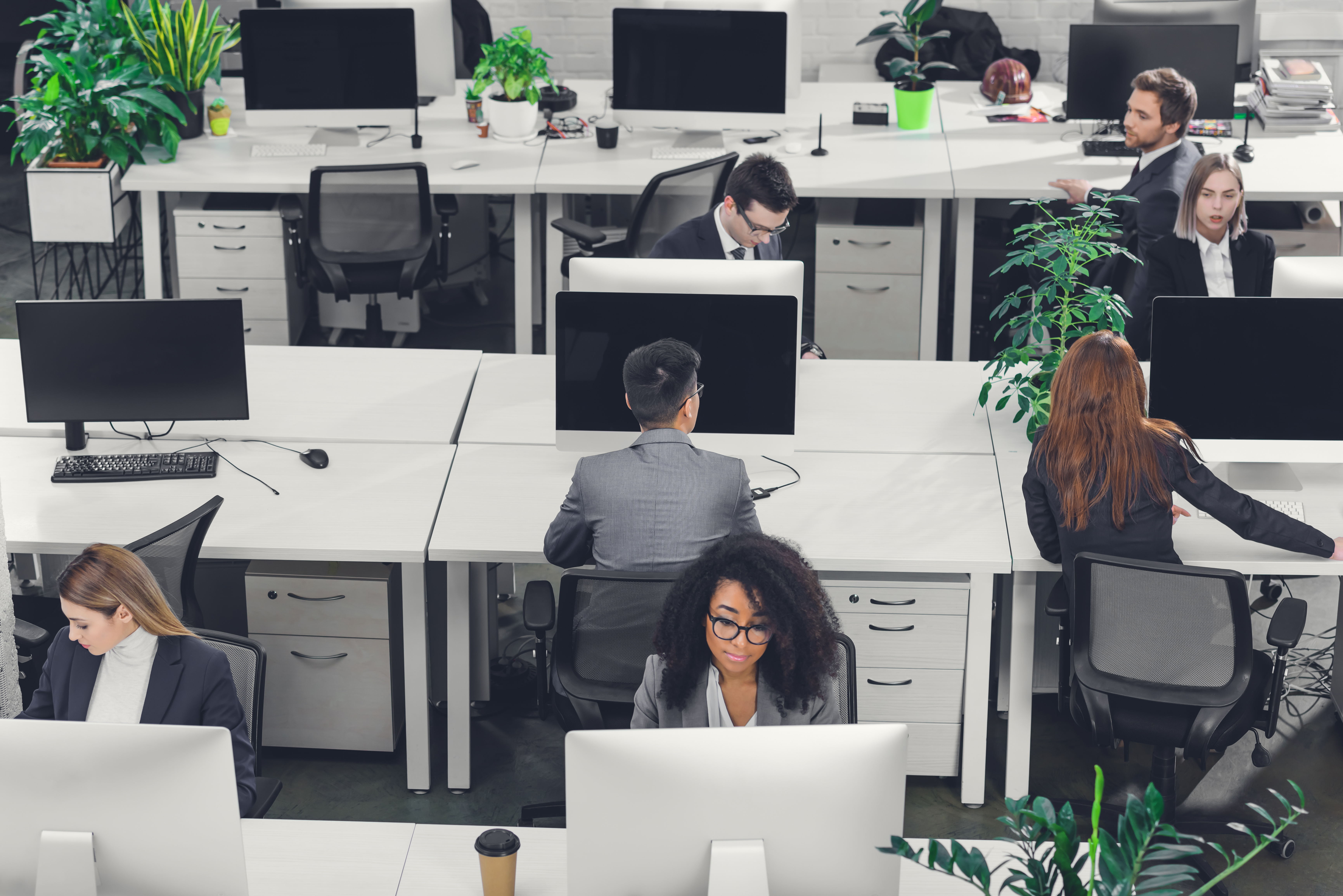 young professionals sitting at their workstations in a contact center